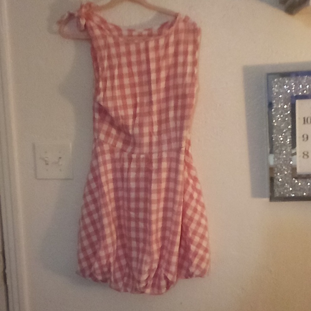Checkered pink and white dress with rounded bottom and tie on one shoulder
